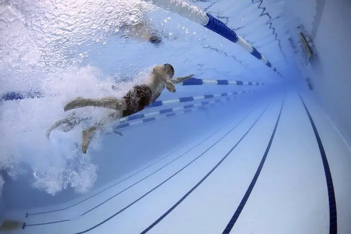 Person swimming in swimming pool an activity that can be tracked with an Apple Watch