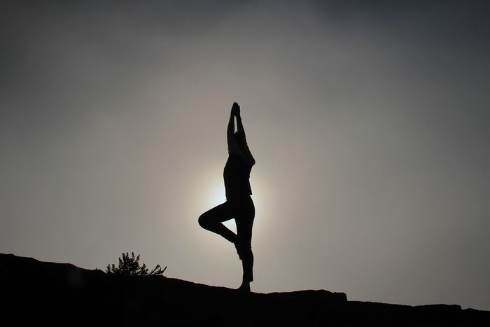 Person striking a yoga pose. Yoga can be tracked using an Apple Watch