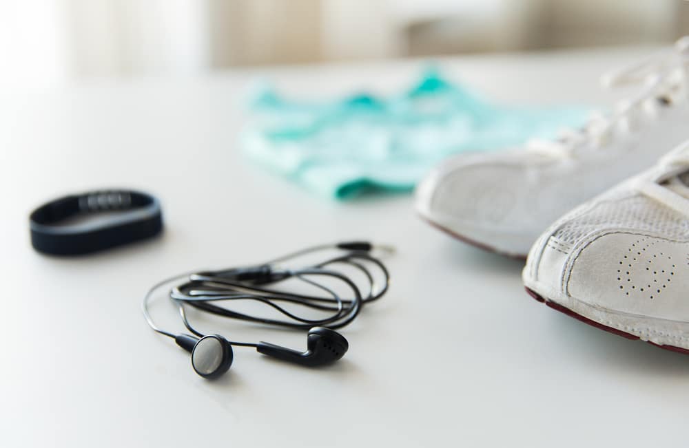 close up of earphones, bracelet and sportswear