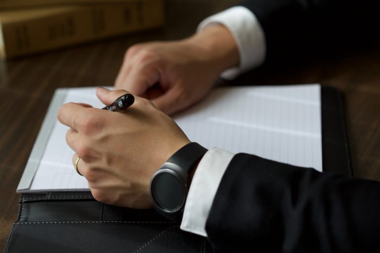 Man wearing a stylish fitness tracker with a suit